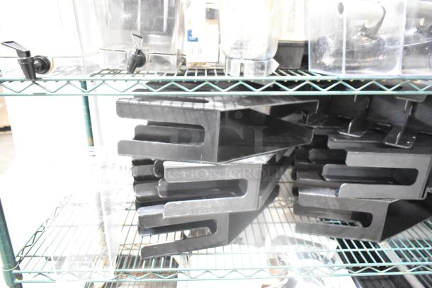 Two-tier lot of black poly lid dispensers and bin set on metal shelving; used condition.
