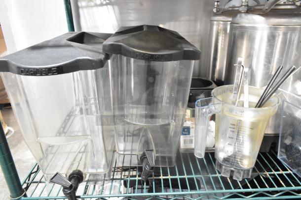 Two-tier lot with Carlisle poly bins, lids, kegs, and hoppers. Includes measuring jug with utensils. Items in used condition.