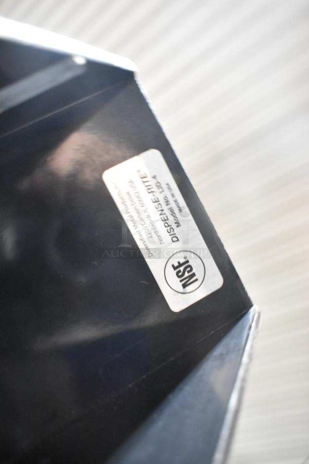 Alt text: Dispense-Rite lid dispenser with NSF certification label visible, part of a mixed item auction lot.