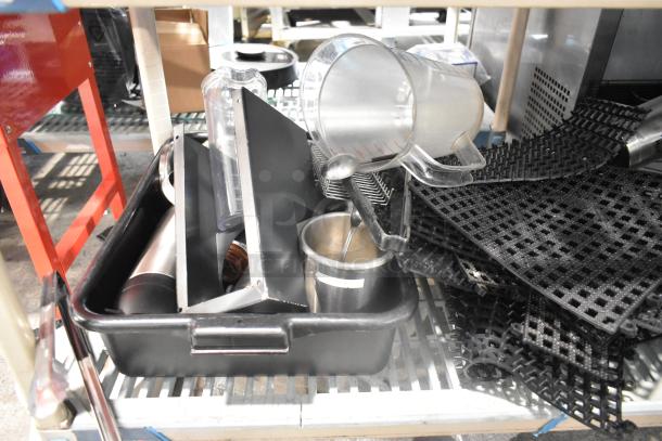 Auction item lot with bus bins, mat pieces, and poly pitchers. Various kitchen and bar tools, good condition.