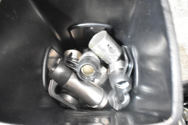 Two black poly trash cans with steel handles visible inside, suitable for multiple uses. Condition appears well-maintained.