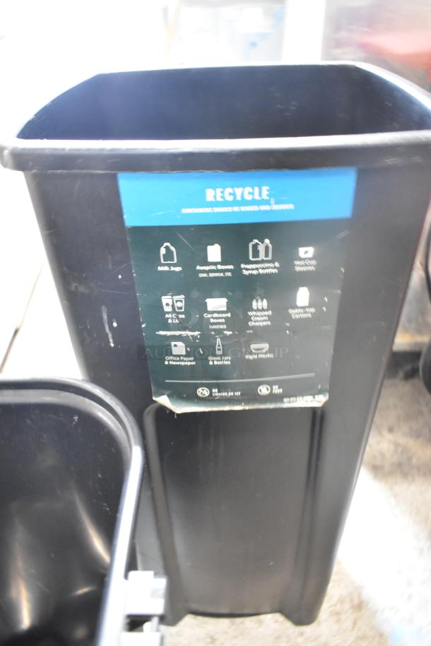 Two black poly trash cans with recycling labels, in good condition. Bid once to receive two cans.