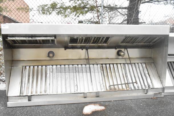 9.5' stainless steel commercial return air grease hood with filters and lights, showing minor wear.
