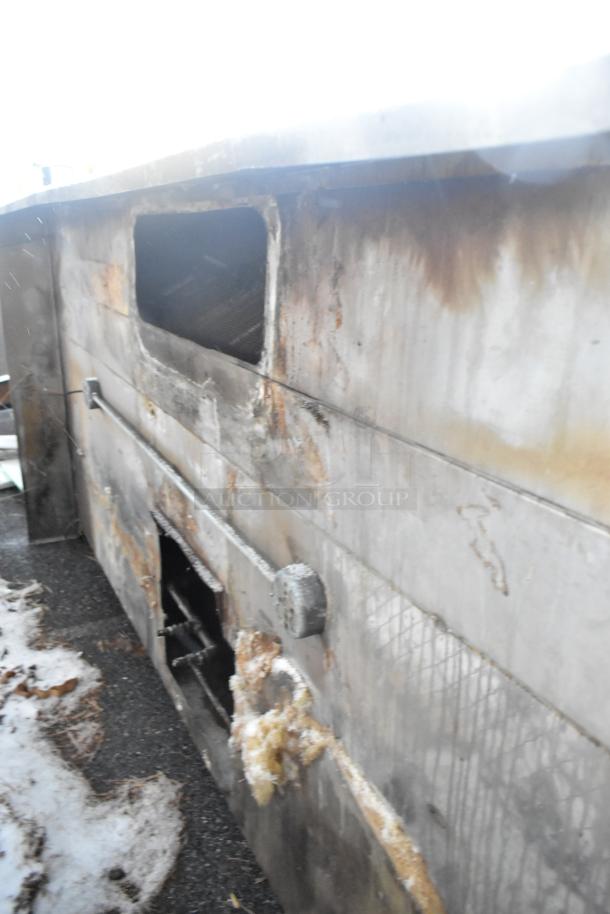 9.5' stainless steel commercial return air grease hood with visible filters and lights, showing signs of wear and use.