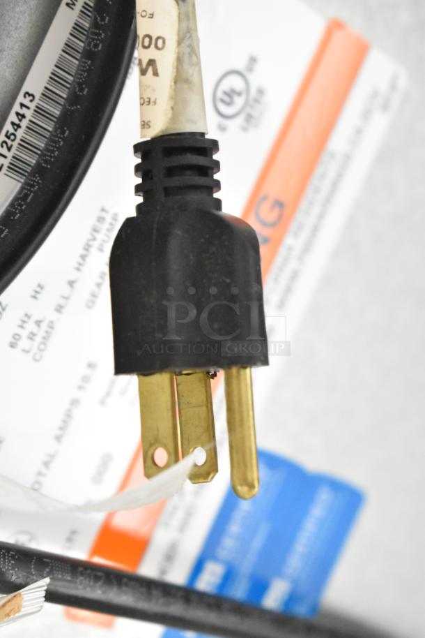 Three-prong plug for a 2025 Manitowoc CNF0202A-161L ice maker. UL certified. Tag reads "W" and other specs.