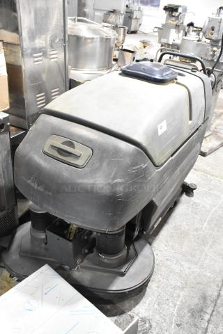 Nilfisk Advance floor cleaning machine, used condition, visible scuffs on body. Model label indicates "220."