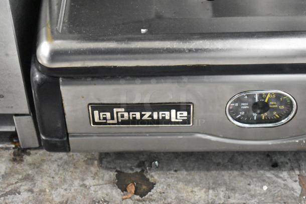 La Spaziale stainless steel commercial espresso machine, scratch and dent, with branding and pressure gauge visible.