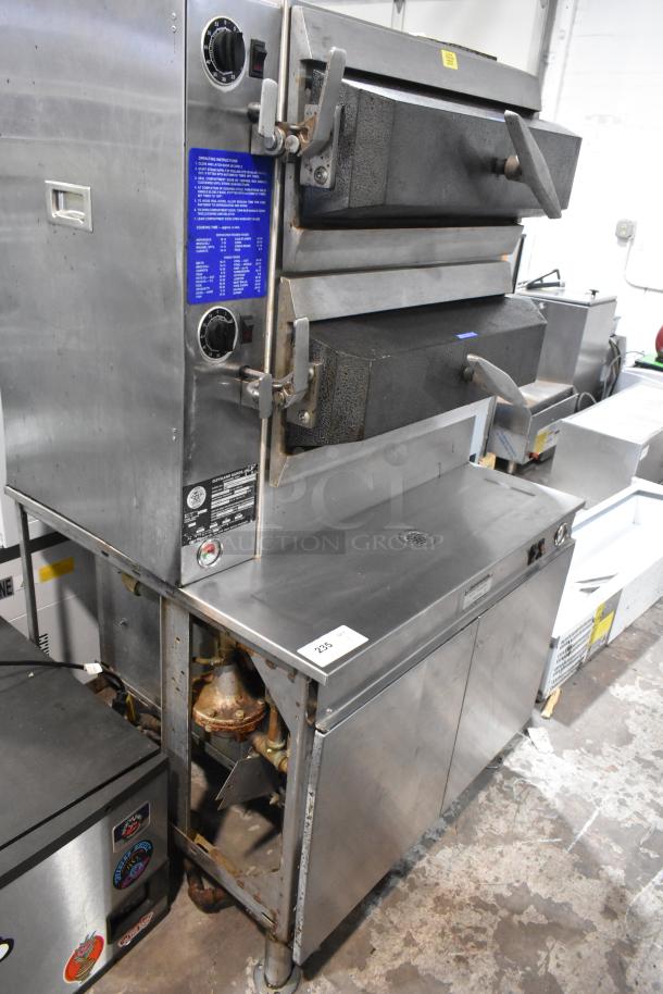 Cleveland PGM2002 stainless steel 2-deck pressure steamer, natural gas, 200,000 BTU, used condition, labels visible.