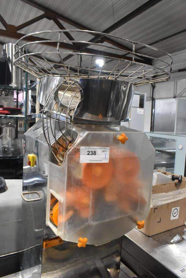 JuiceMatic MJ40 stainless steel citrus juicer on casters, automatic feed, 115V, 1-phase. Tag indicates auction lot 238.