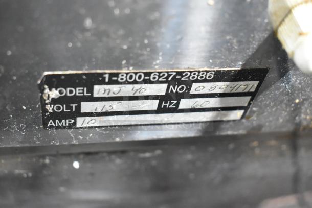 Label on JuiceMatic MJ40 commercial citrus juicer showing model, voltage (115V), amp (10), and serial number 0804711.