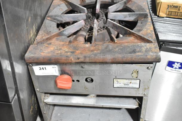 Stainless steel commercial gas single burner stock pot range with rusted top, control knob, and item tag visible.