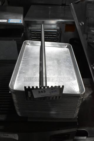 Stack of metal baking pans with a metal rod, labeled "243, QTY 25," auction item featuring 25 times bid multiplier.