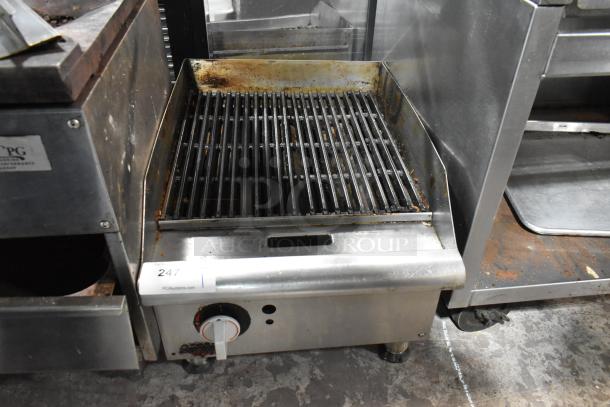APW Wyott stainless steel countertop gas charbroiler grill, commercial use, visible wear, adjustable knob, label "247".