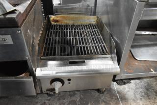 APW Wyott stainless steel countertop gas charbroiler grill, commercial use, visible wear, adjustable knob, label "247".