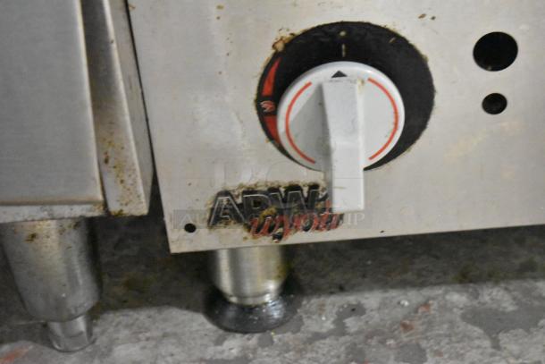 APW Wyott stainless steel gas charbroiler grill, showing control knob and branded panel, moderate wear visible.