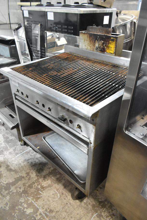 Rankin Delux RB-836 stainless steel charbroiler grill with under shelf, natural gas, on commercial casters, visible wear.
