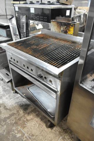 Rankin Delux RB-836 stainless steel charbroiler grill with under shelf, natural gas, on commercial casters, visible wear.