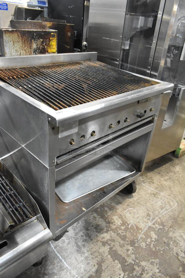 Rankin Delux RB-836 stainless steel gas charbroiler grill with under shelf, commercial casters, visible wear.