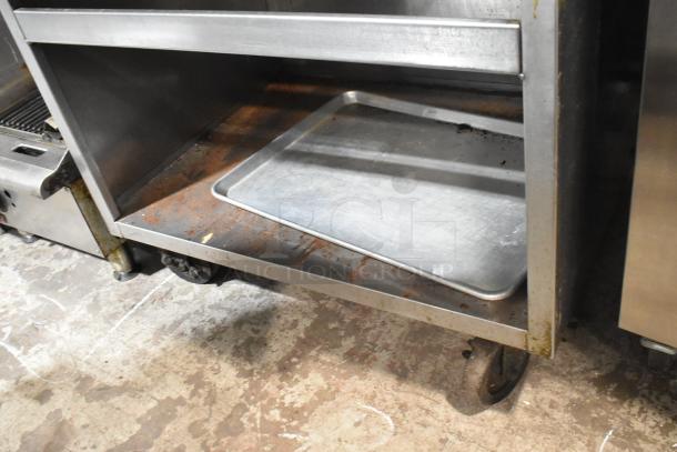 Rankin Delux RB-836 stainless steel charbroiler grill with under shelf, on commercial casters, showing rust and wear.