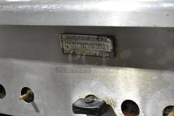 Rankin Delux RB-836 stainless steel charbroiler grill, natural gas, commercial casters, visible logo plate, used condition.