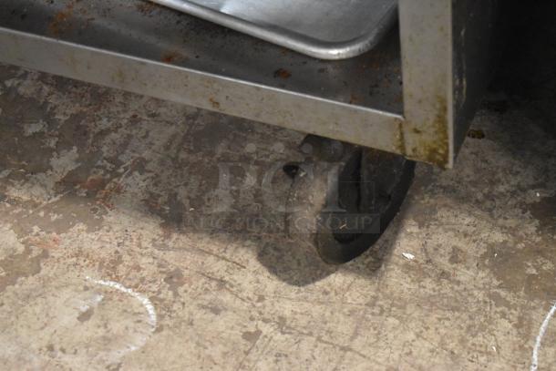 Rankin Delux RB-836 stainless steel charbroiler grill on casters, with visible surface rust and under-shelf tray.