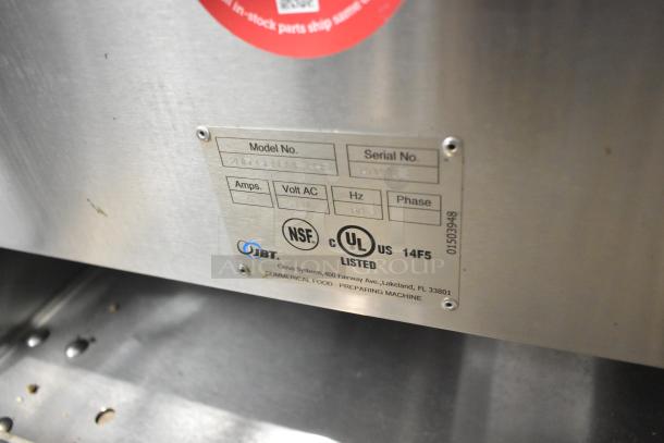 Stainless steel JBT 2ND-GEN-MFJ-HE citrus juicer on casters, showing model label with 120V, 1-phase specs.