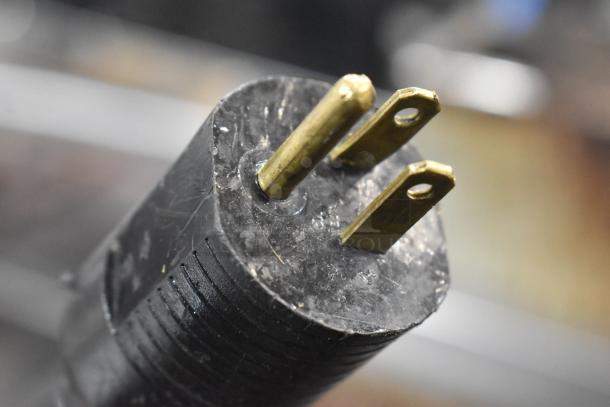 Close-up of a power plug for a JBT 2ND-GEN-MFJ-HE Fresh N Squeeze Citrus Juicer, showing prongs and slight wear.