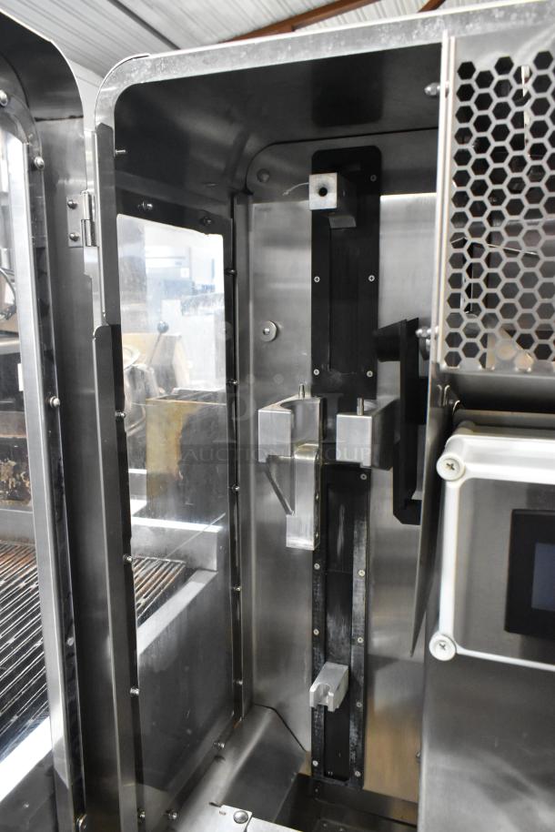 LATE MODEL JBT 2ND-GEN-MFJ-HE citrus juicer, stainless steel, commercial floor style, on casters, showing internal components.