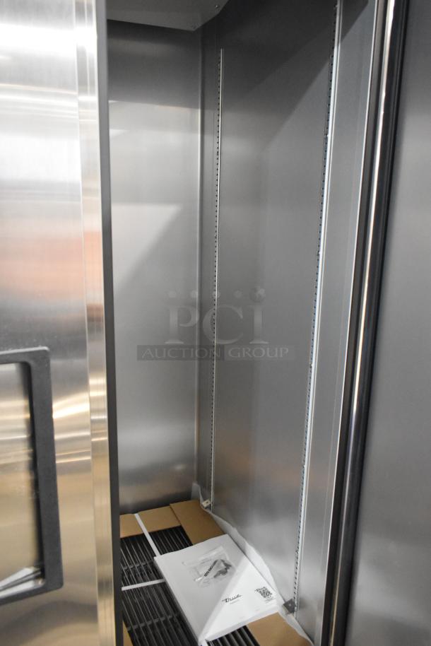 Stainless steel interior of 2025 True T-35-HC commercial 2-door cooler with poly-coated racks, signs of minor dent.