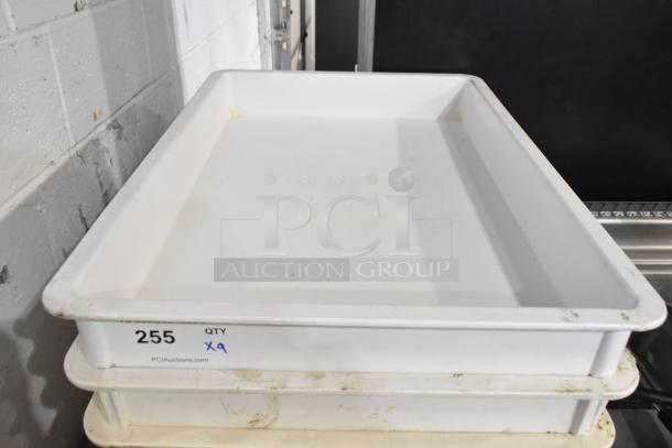 9 white poly dough bins, used condition, stackable, quantity marked as 9, shown with slight discoloration and wear.