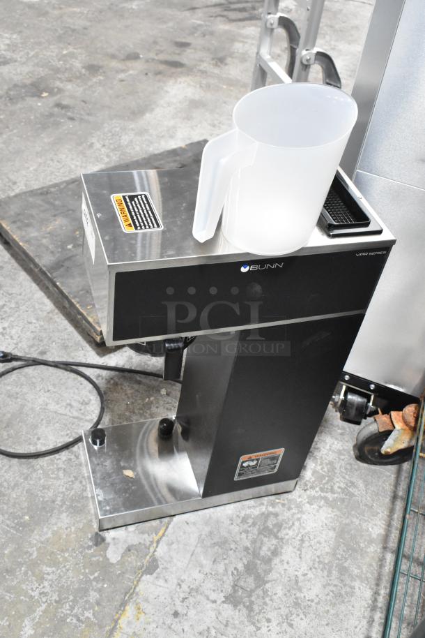 Brand new Bunn VPR-APS commercial coffee machine, stainless steel, 120 volts, with visible scratch and warning label.