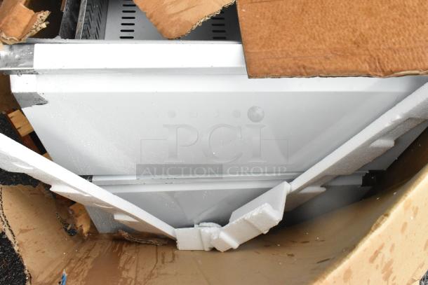 Box with scratch and dent stainless steel drawers, model PICL1-TR-HC, for prep table, partially opened for inspection.