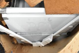 Box with scratch and dent stainless steel drawers, model PICL1-TR-HC, for prep table, partially opened for inspection.