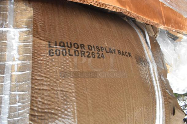 Cardboard box labeled "Liquor Display Rack 600LDR2624," part of a lot including new Regency stainless steel items.