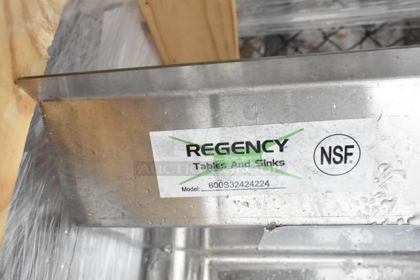 Regency 600S32424224 stainless steel 3-bay sink with dual drain boards, brand new with scratches, no legs; NSF certified.