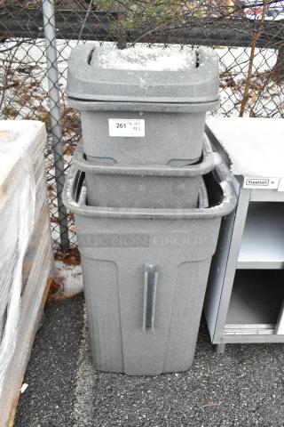 Three brand new gray poly trash cans, labeled for scratch and dent, with visible lid and body, stacked outdoors. Tags indicate auction item.