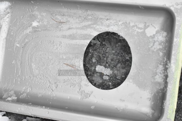 Stainless steel meat grinder tray with visible scratches and dents; brand new condition despite imperfections.