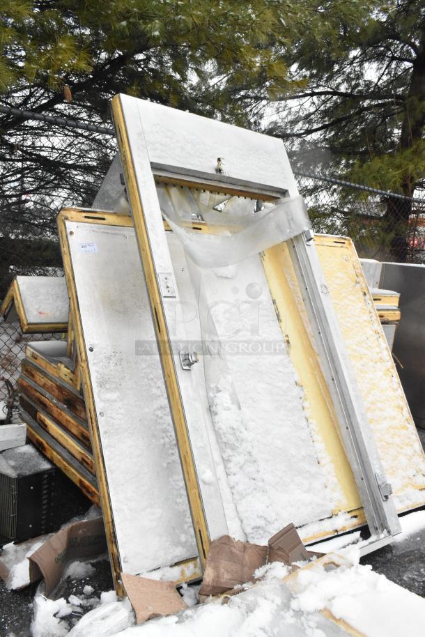 Walk-in box with compressor, LCA672AB evaporator fan, 115V, 1 phase, snow-covered condition, metal frame, outdoor setting.