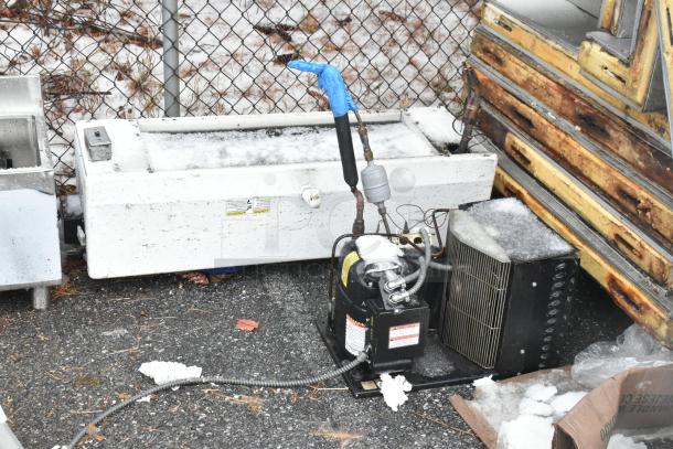 Walk-in box compressor with LCA672AB 115 Volt, 1 Phase evaporator fan. Used condition with visible snow and ice.
