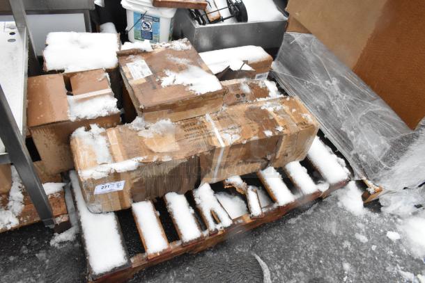 Snow-covered pallet with multiple boxes, including 600SRS36S Regency Spec Line speed rail, showcasing visible labels.
