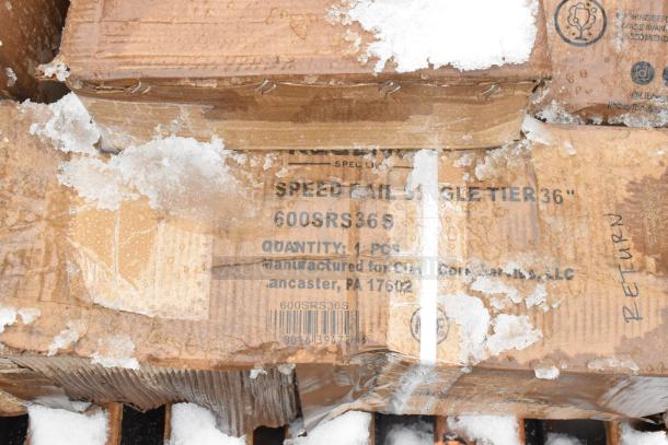 Box with Regency Spec Line 36" Speed Rail 600SRS36S label, lightly snow-covered, indicating new scratch and dent condition.