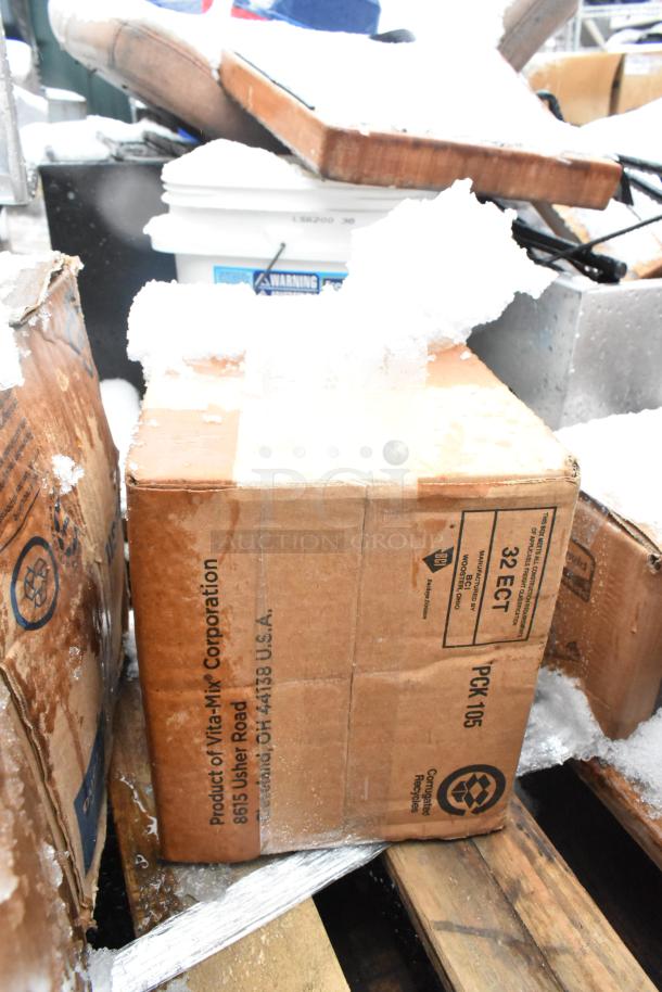 Box labeled "Vita-Mix Corporation," covered in snow, indicates shipment from Cleveland, Ohio; part of a scratch and dent auction lot.