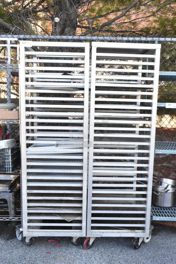 Two metal commercial pan transport racks with casters, used condition, ideal for kitchen or catering use.