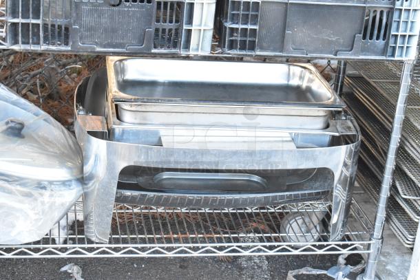 Chrome finish 4-tier wire shelving unit with contents including a chafer, mixing bowls, whisk attachments, and skillets.