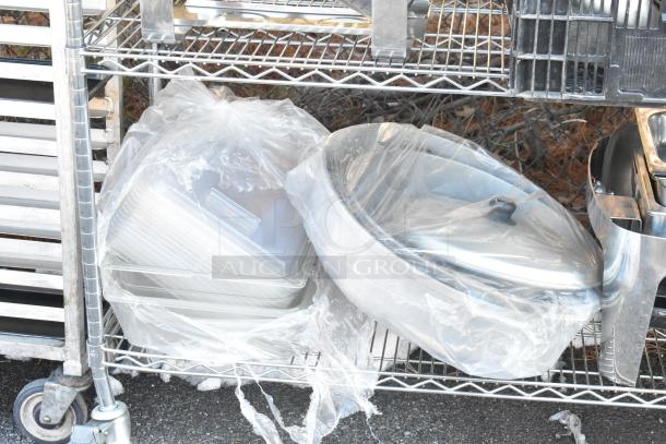 Chrome finish 4-tier wire shelving unit with chafer, mixing bowls, whisk attachments, skillets. Buyer must dismantle.