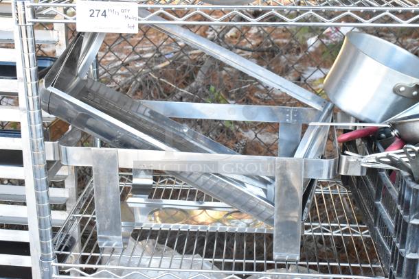 Chrome 4-tier wire shelving unit holding chafers, mixing bowls, and whisks. Requires dismantling. Auction label shows lot number.