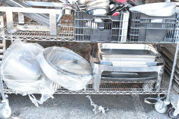 Chrome finish 4-tier wire shelving unit with mixing bowls, chafer, whisk attachments, and skillets; buyer must dismantle.