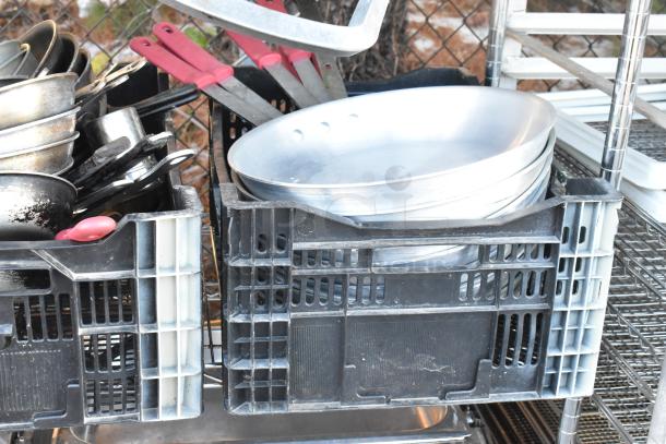 Chrome 4-tier wire shelving unit with contents: chafer, mixing bowls, whisks, skillets in crates. Buyer must dismantle.