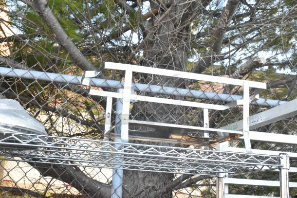Chrome finish 4-tier wire shelving unit with chafer, mixing bowls, whisk attachments, and skillets. Buyer must dismantle.
