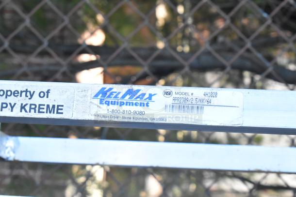 KelMax Equipment metal pan transport rack with commercial casters, Model #4H1020, used, showing property label.